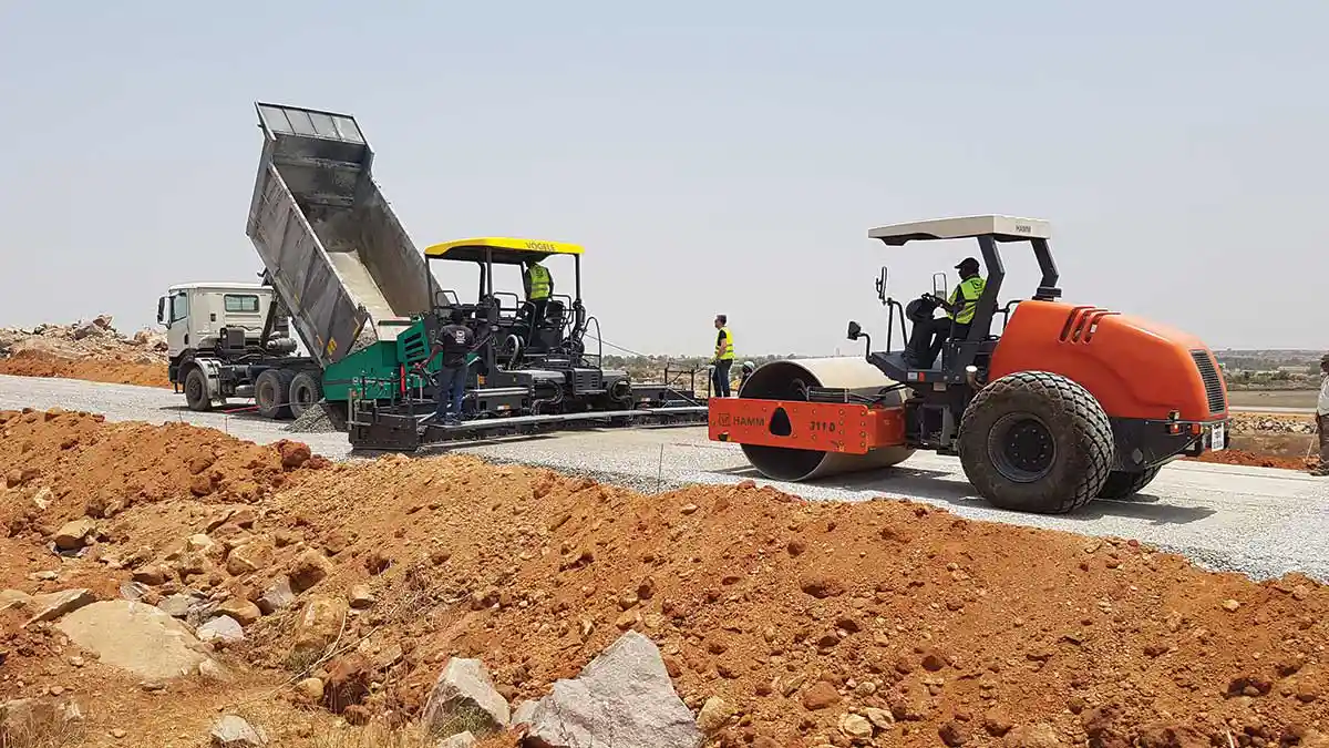 Asphalt paving with paver and roller